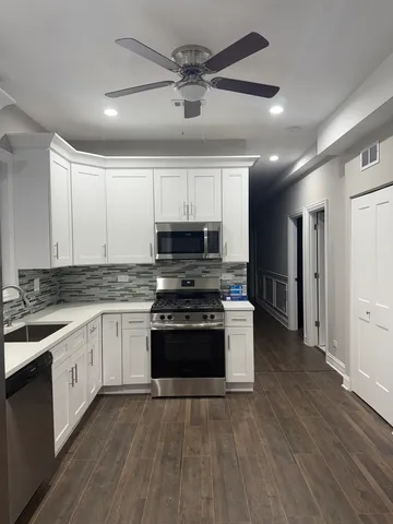 a kitchen with stainless steel appliances granite countertop a stove and a sink