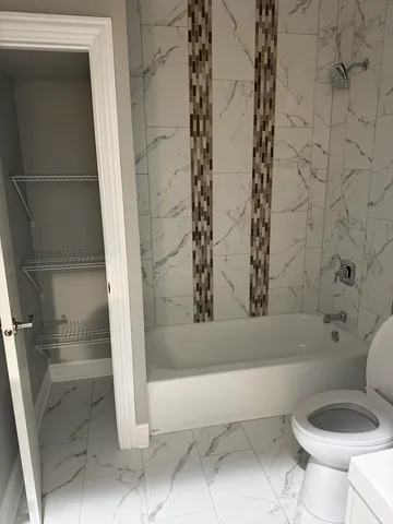a bathroom with a toilet and a shower