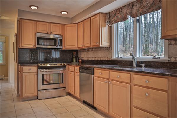 105 Scotland Road Newbury, MA 01951 - Photo 8 of 24 a kitchen with granite countertop a sink stainless steel appliances and cabinets