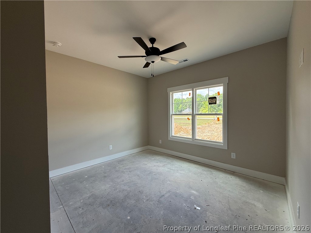 132 Ridge Stone Drive Autryville, NC 28318 - Photo 19 of 26 an empty room with a window and a ceiling fan