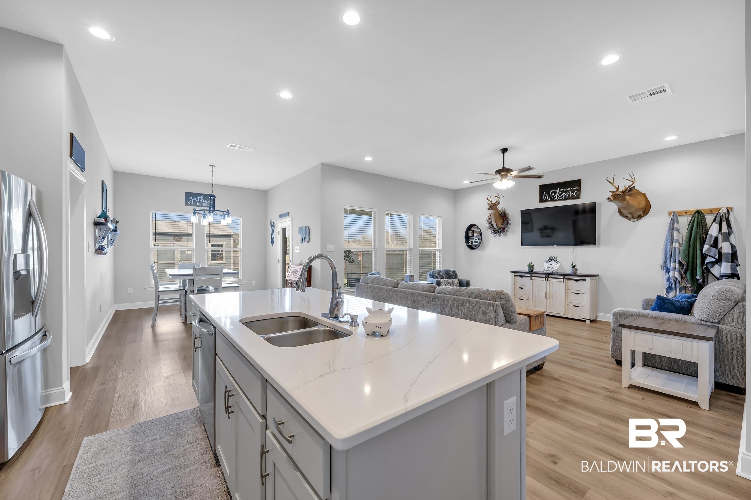1176 Stella Road Foley, AL 36535 - Photo 40 of 40 Kitchen with open floor plan, stainless steel appliances, light wood-style flooring, a kitchen island with sink, and ceiling fan