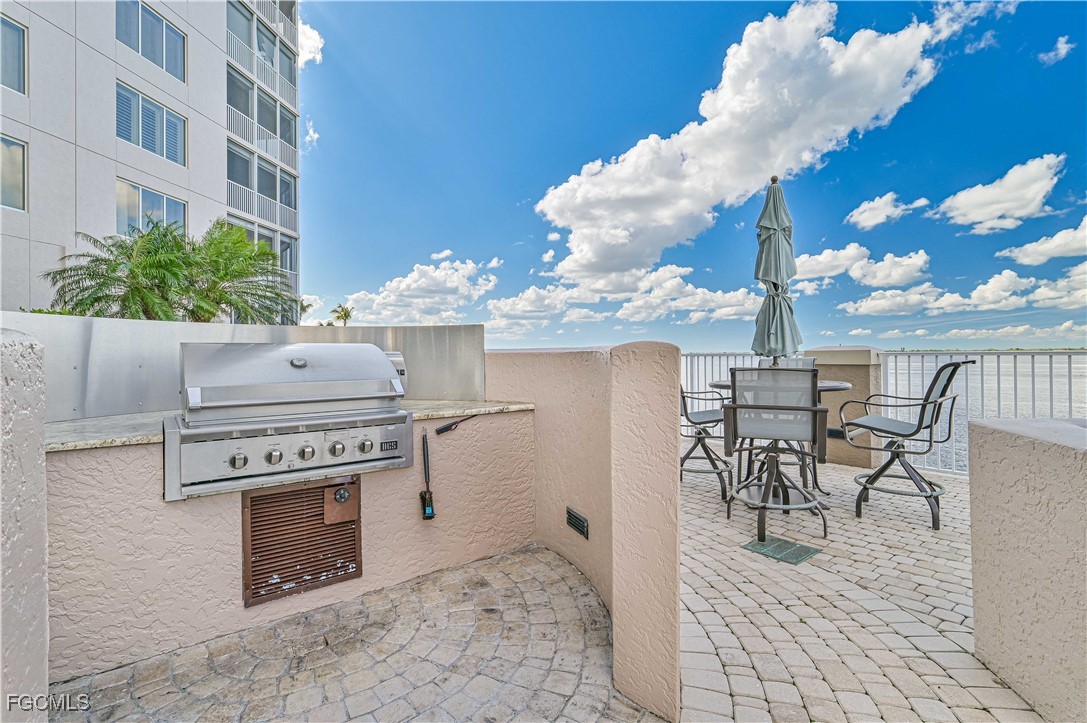 2104 West First Street, Unit 1701 Fort Myers, FL 33901 - Photo 25 of 48 a view of a dinning tables and chairs in the patio