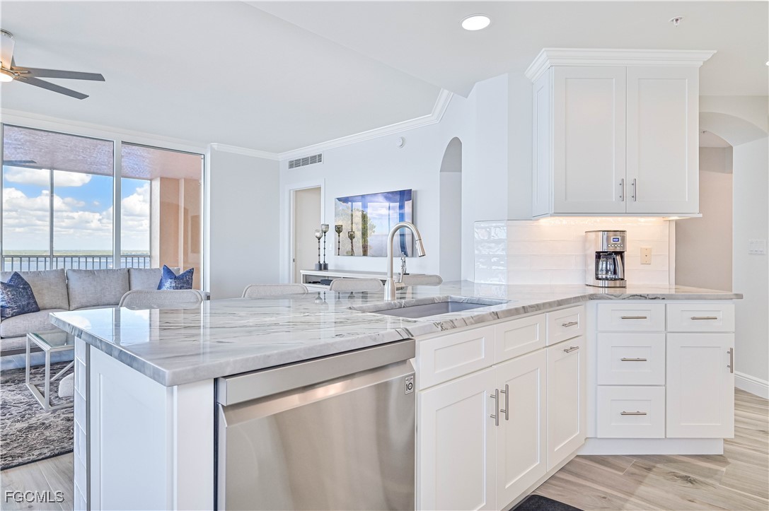 2104 West First Street, Unit 1701 Fort Myers, FL 33901 - Photo 30 of 48 a kitchen with white cabinets and sink