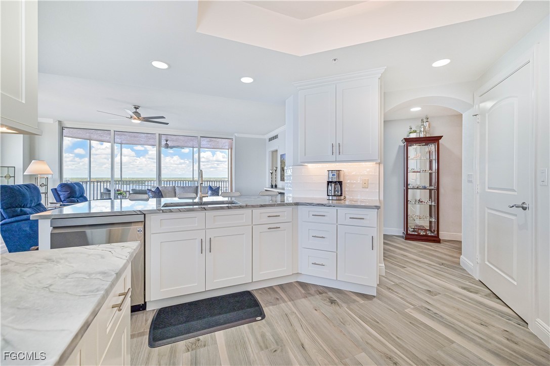2104 West First Street, Unit 1701 Fort Myers, FL 33901 - Photo 31 of 48 a open kitchen with granite countertop white cabinets and white appliances