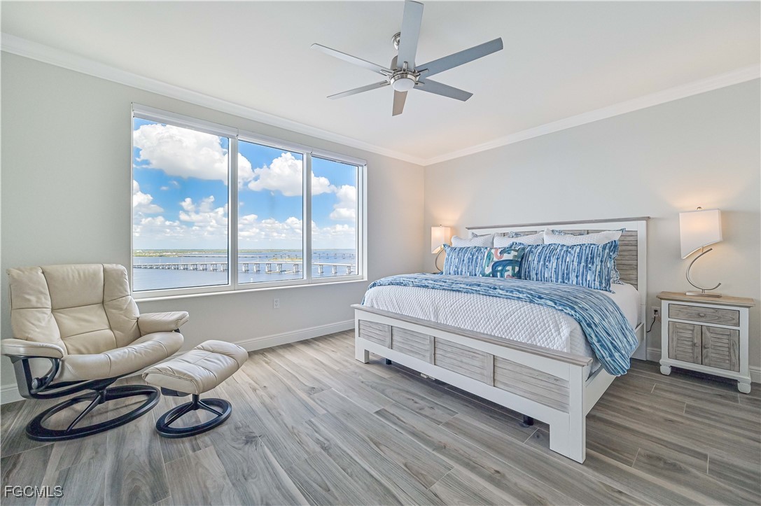 2104 West First Street, Unit 1701 Fort Myers, FL 33901 - Photo 37 of 48 a spacious bedroom with a bed and wooden floor