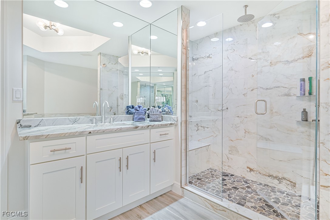 2104 West First Street, Unit 1701 Fort Myers, FL 33901 - Photo 38 of 48 a bathroom with a shower sink and mirror
