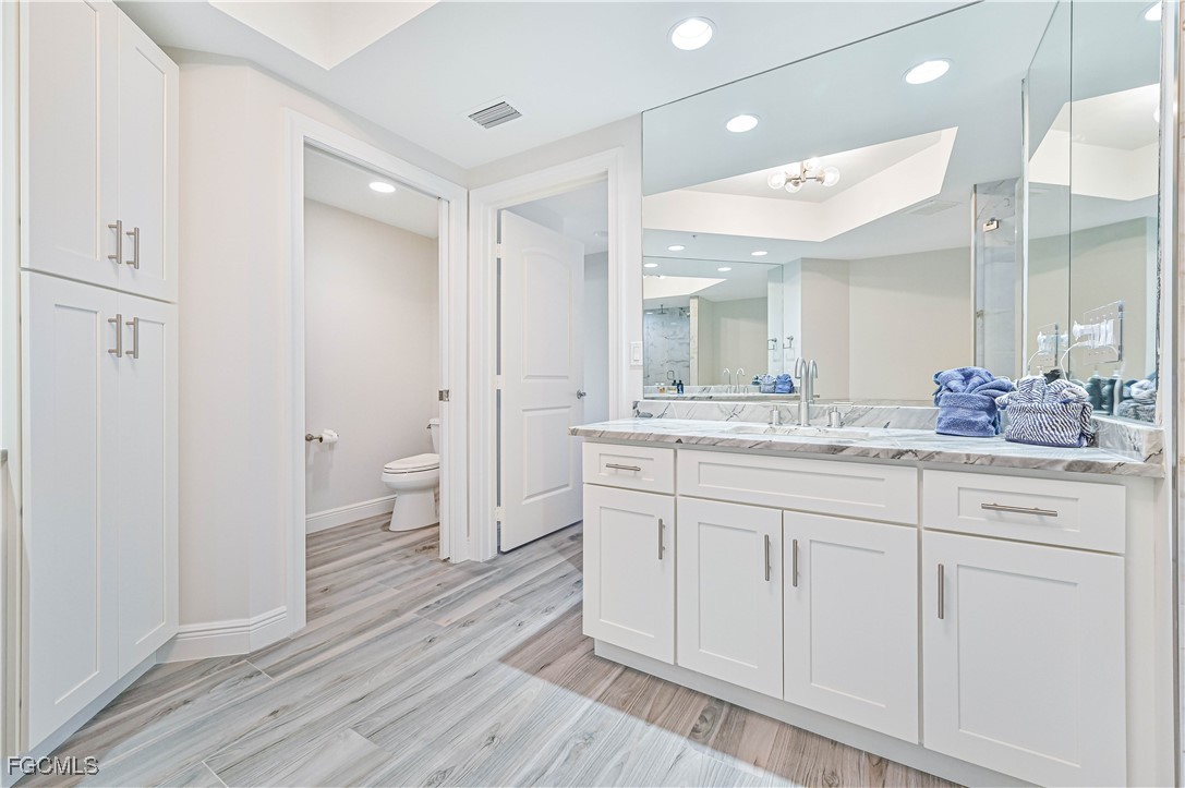 2104 West First Street, Unit 1701 Fort Myers, FL 33901 - Photo 39 of 48 a bathroom with a granite countertop sink mirror and toilet