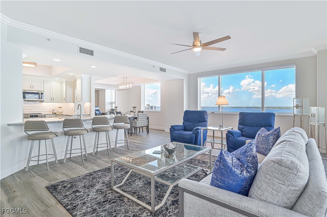 2104 West First Street, Unit 1701 Fort Myers, FL 33901 - Photo 4 of 48 a living room with lots of furniture and a table