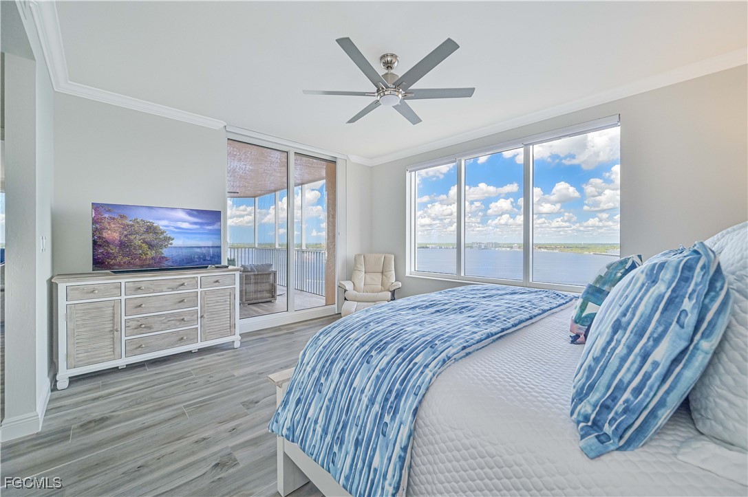 2104 West First Street, Unit 1701 Fort Myers, FL 33901 - Photo 10 of 48 a bedroom with a bed and a large window