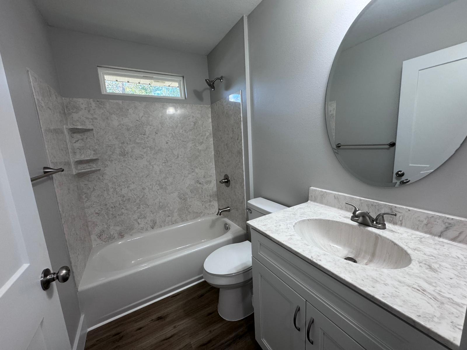1787 Dads Road Baker, FL 32531 - Photo 11 of 20 a bathroom with a granite countertop sink toilet and shower
