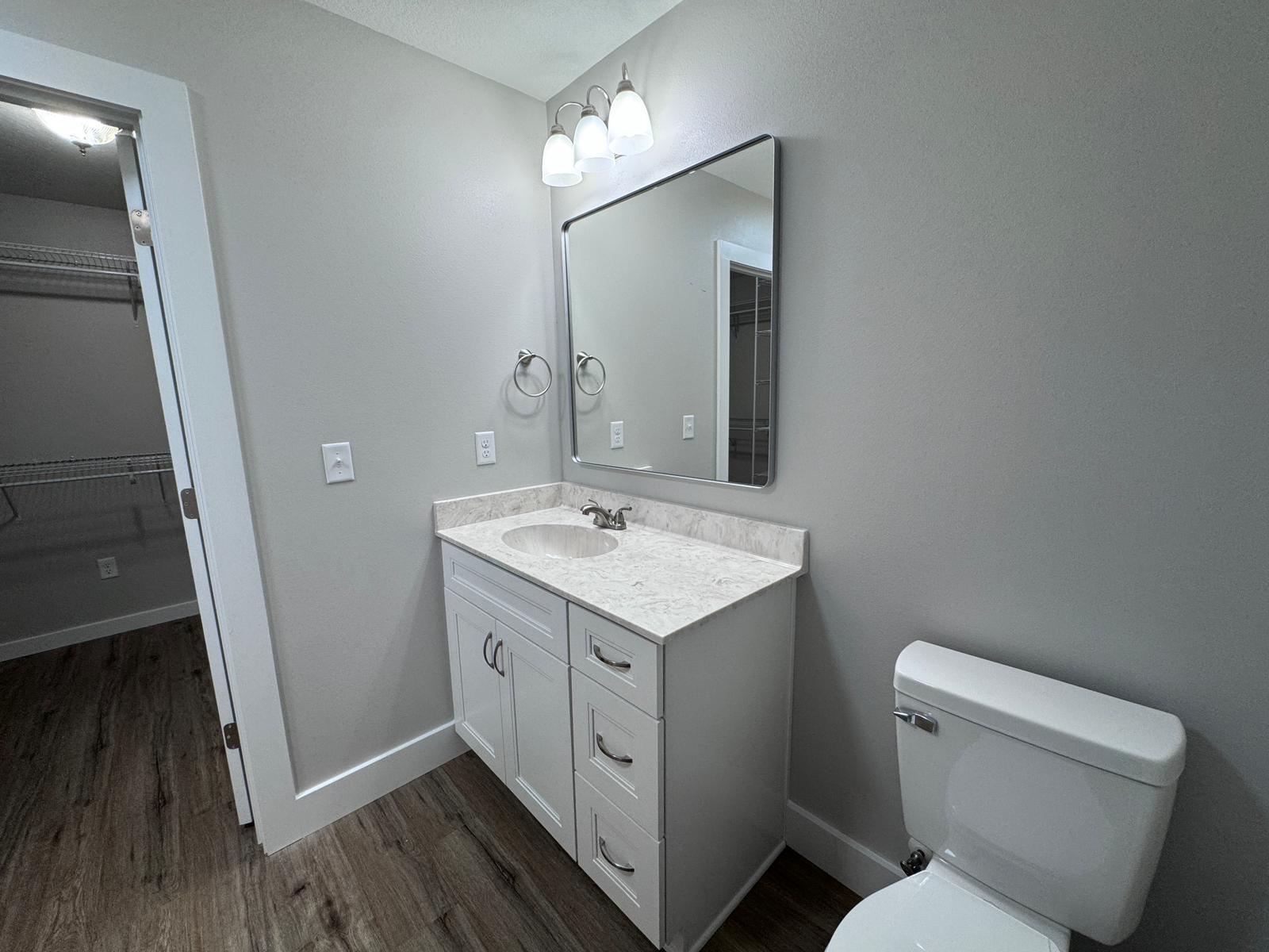 1787 Dads Road Baker, FL 32531 - Photo 14 of 20 a bathroom with a toilet sink and mirror
