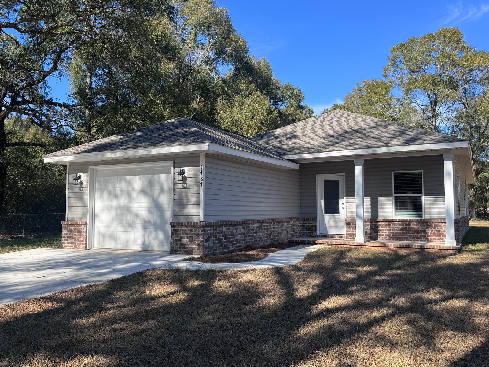1787 Dads Road Baker, FL 32531 - Photo 2 of 20 a front view of a house with a yard