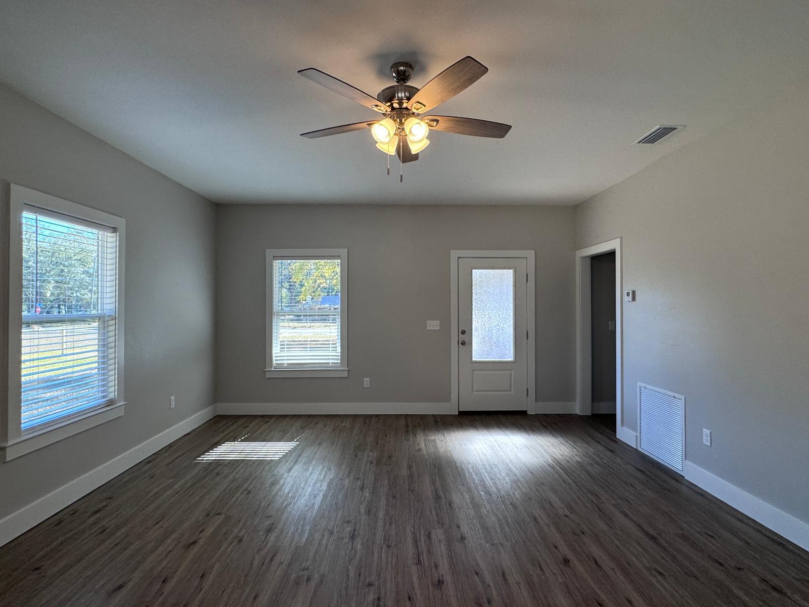 1787 Dads Road Baker, FL 32531 - Photo 3 of 20 a view of an empty room with wooden floor and a window