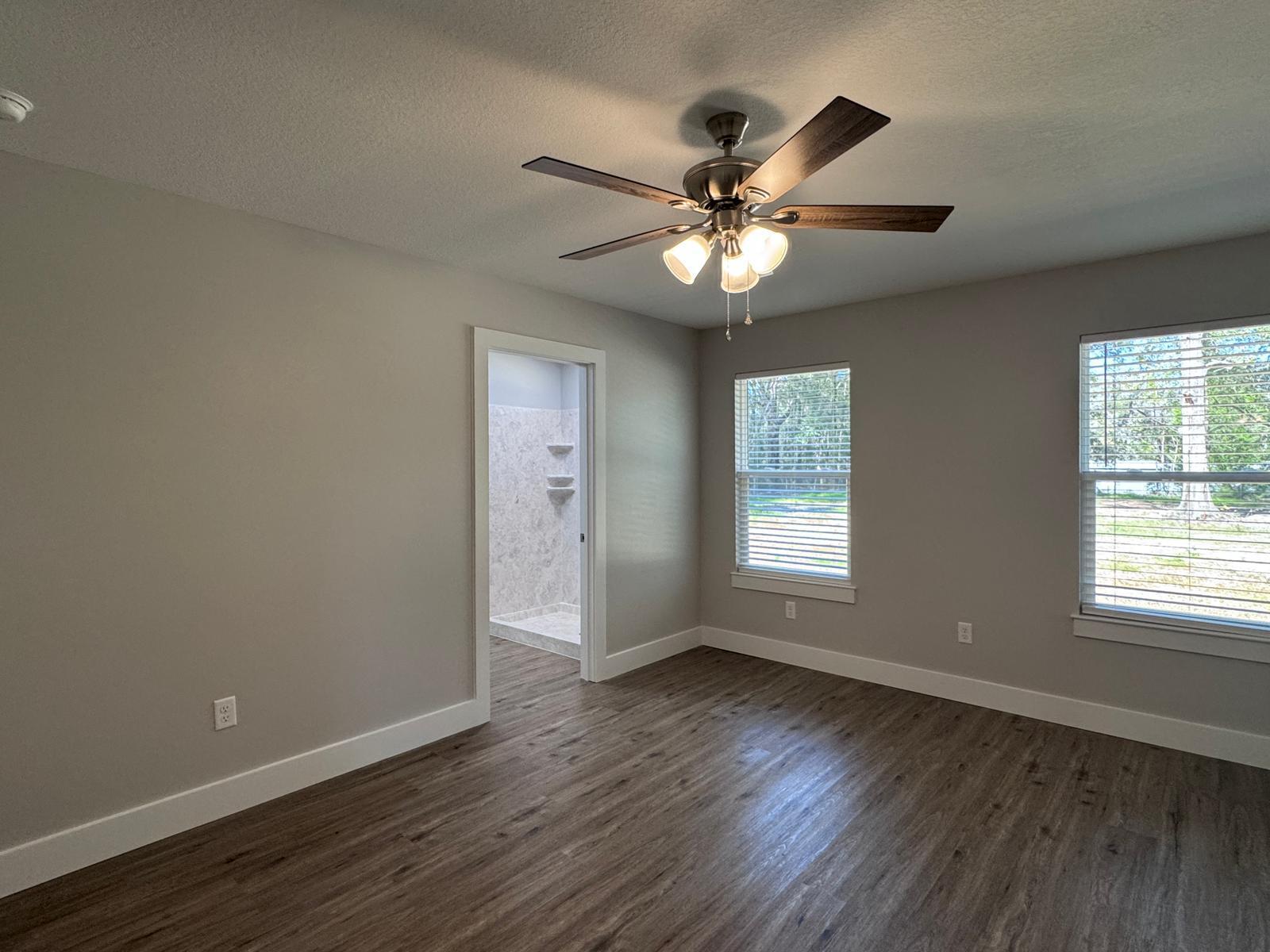1787 Dads Road Baker, FL 32531 - Photo 9 of 20 a view of an empty room with wooden floor and a window