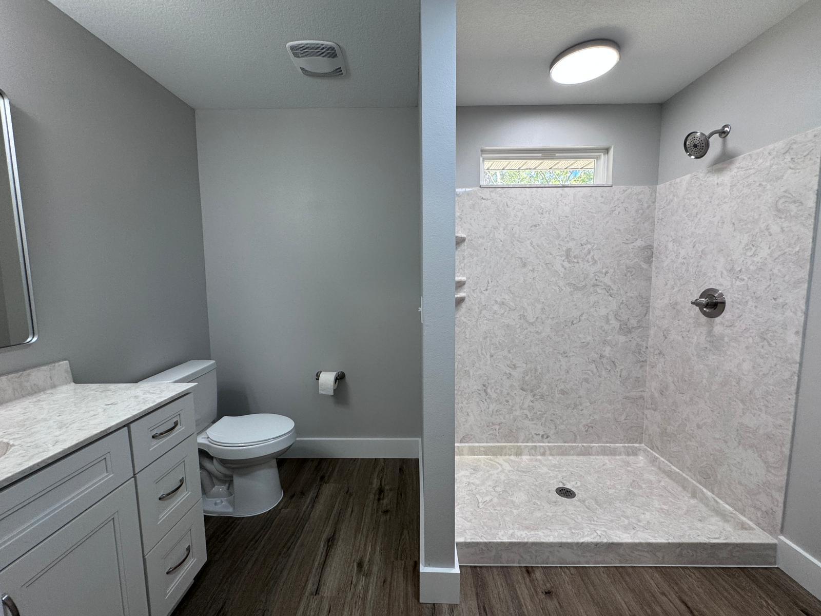 1787 Dads Road Baker, FL 32531 - Photo 10 of 20 a bathroom with a granite countertop sink toilet a mirror and shower