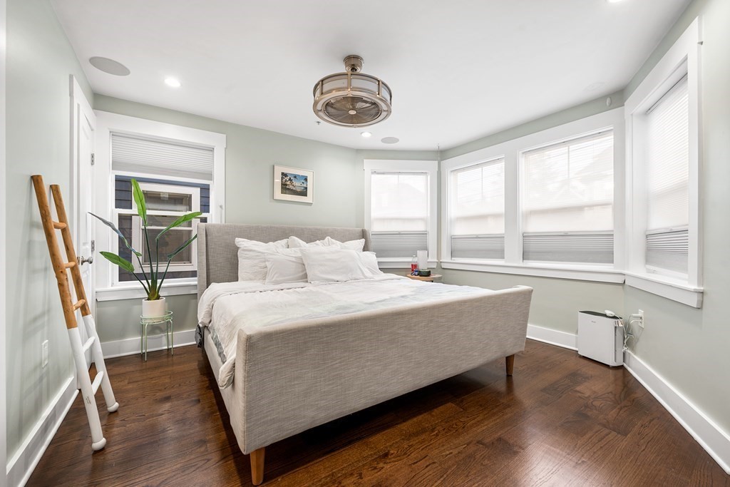 13 Ruthven Street, Unit 1 Boston, MA 02121 - Photo 13 of 35 a bed room with a bed and a chair