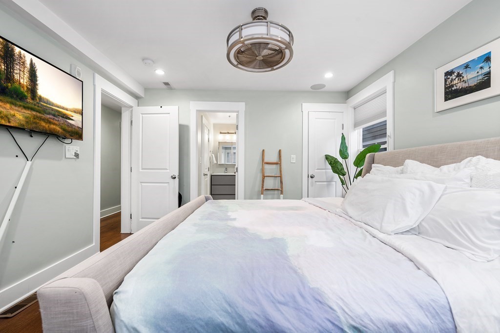 13 Ruthven Street, Unit 1 Boston, MA 02121 - Photo 14 of 35 a bedroom with a bed and a chandelier