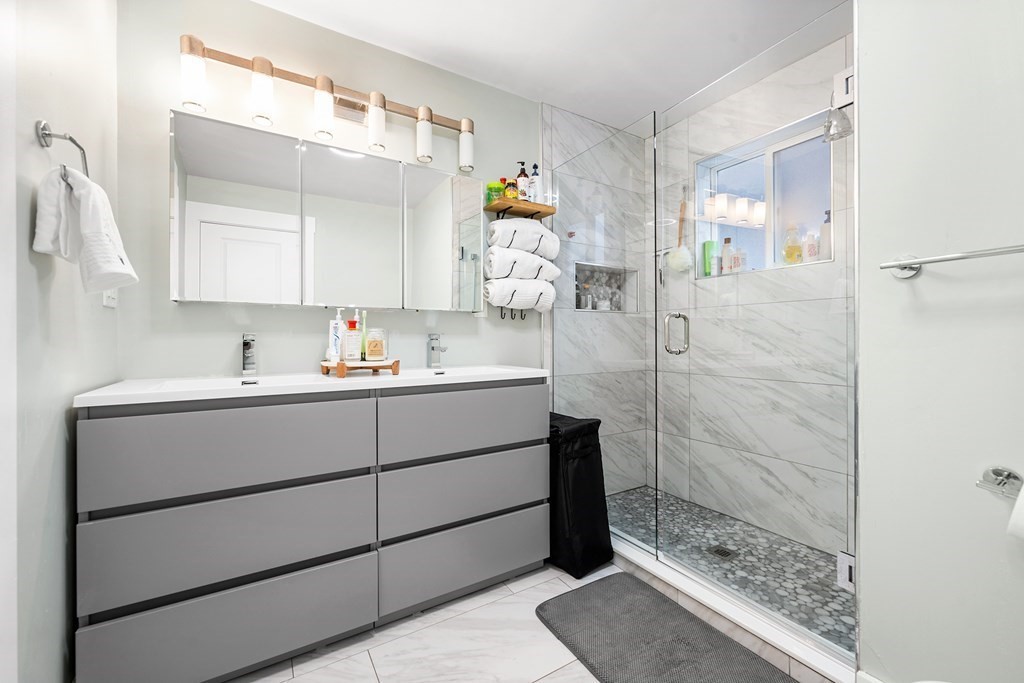 13 Ruthven Street, Unit 1 Boston, MA 02121 - Photo 15 of 35 a bathroom with a shower sink and mirror