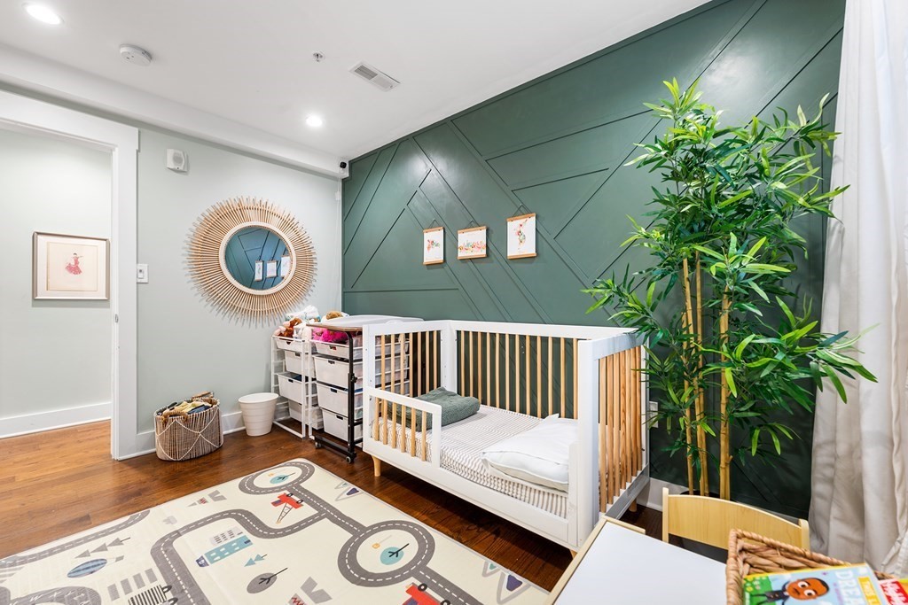 13 Ruthven Street, Unit 1 Boston, MA 02121 - Photo 17 of 35 a bedroom with furniture and a potted plant