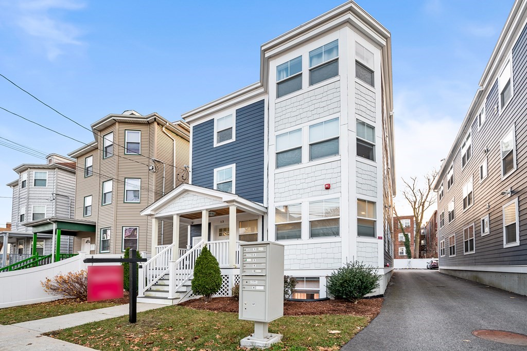 13 Ruthven Street, Unit 1 Boston, MA 02121 - Photo 2 of 35 a front view of a house with a yard