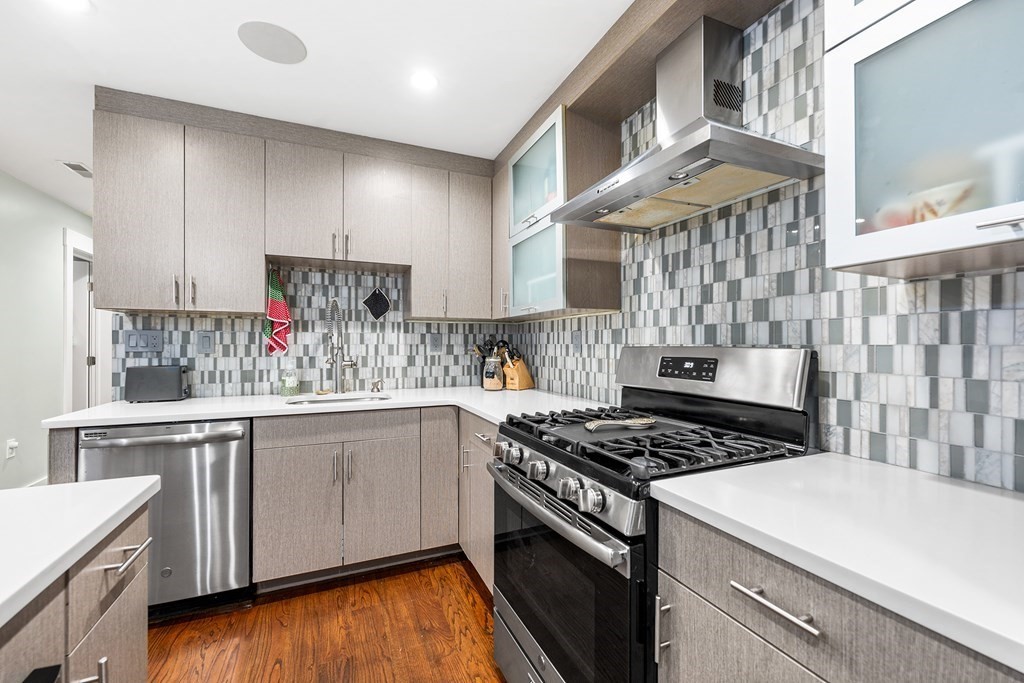 13 Ruthven Street, Unit 1 Boston, MA 02121 - Photo 9 of 35 a kitchen with a stove a sink and cabinets
