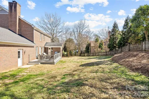 a view of a yard with wooden fence