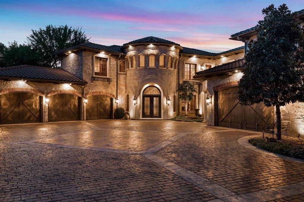 2115 Paradise Rnch Trail McKinney, TX 75071 - Photo 39 of 40 Stone-clad exterior featuring a prominent circular turret and arched window accents
