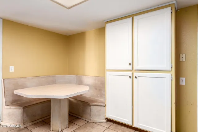 an empty room with windows and closet