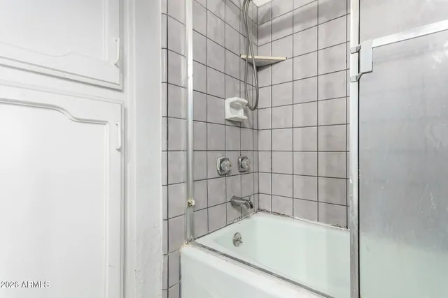 a bathroom with a sink a mirror a toilet and a shower