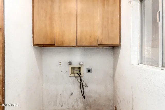 a view of a kitchen with white cabinets