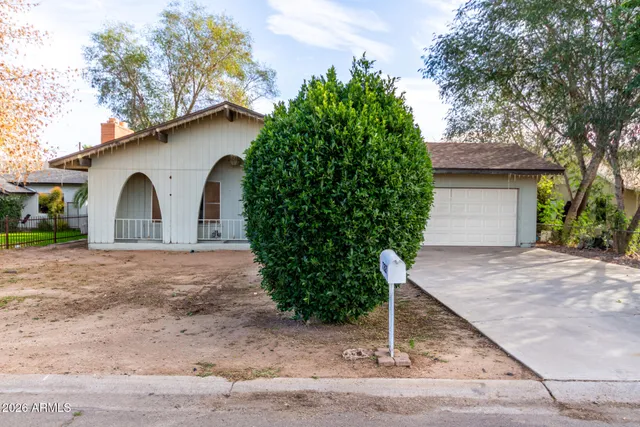 an empty room with windows and fireplace