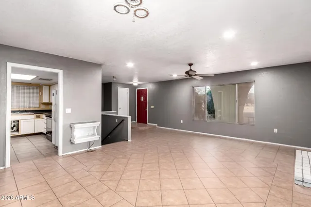 a view of an empty room with window and fire place