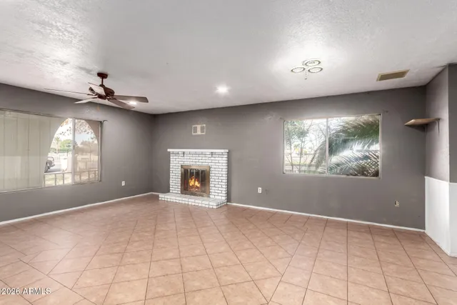 a kitchen with granite countertop a refrigerator stove and white cabinets