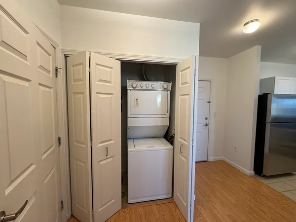a hallway with sliding door and wooden door