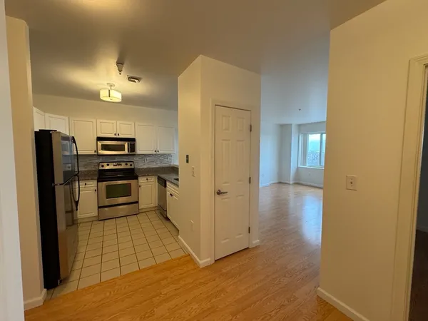 a kitchen with stainless steel appliances granite countertop a refrigerator and a stove top oven