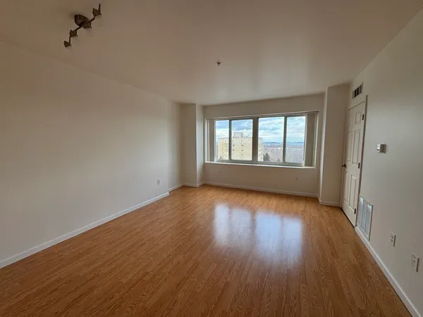 wooden floor in an empty room with a window