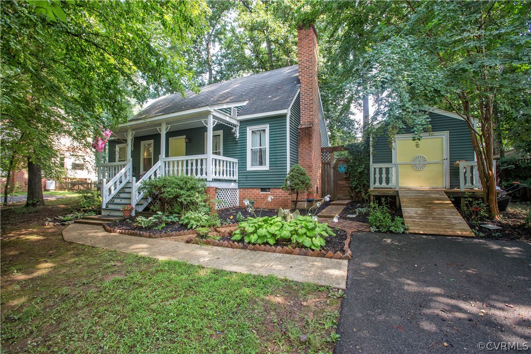 a front view of a house with a yard and potted plants