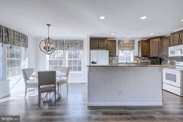 a living room with granite countertop furniture and a wooden floor