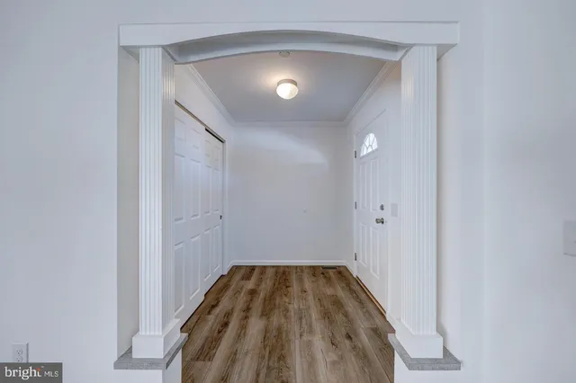 a view of a hallway with wooden floor