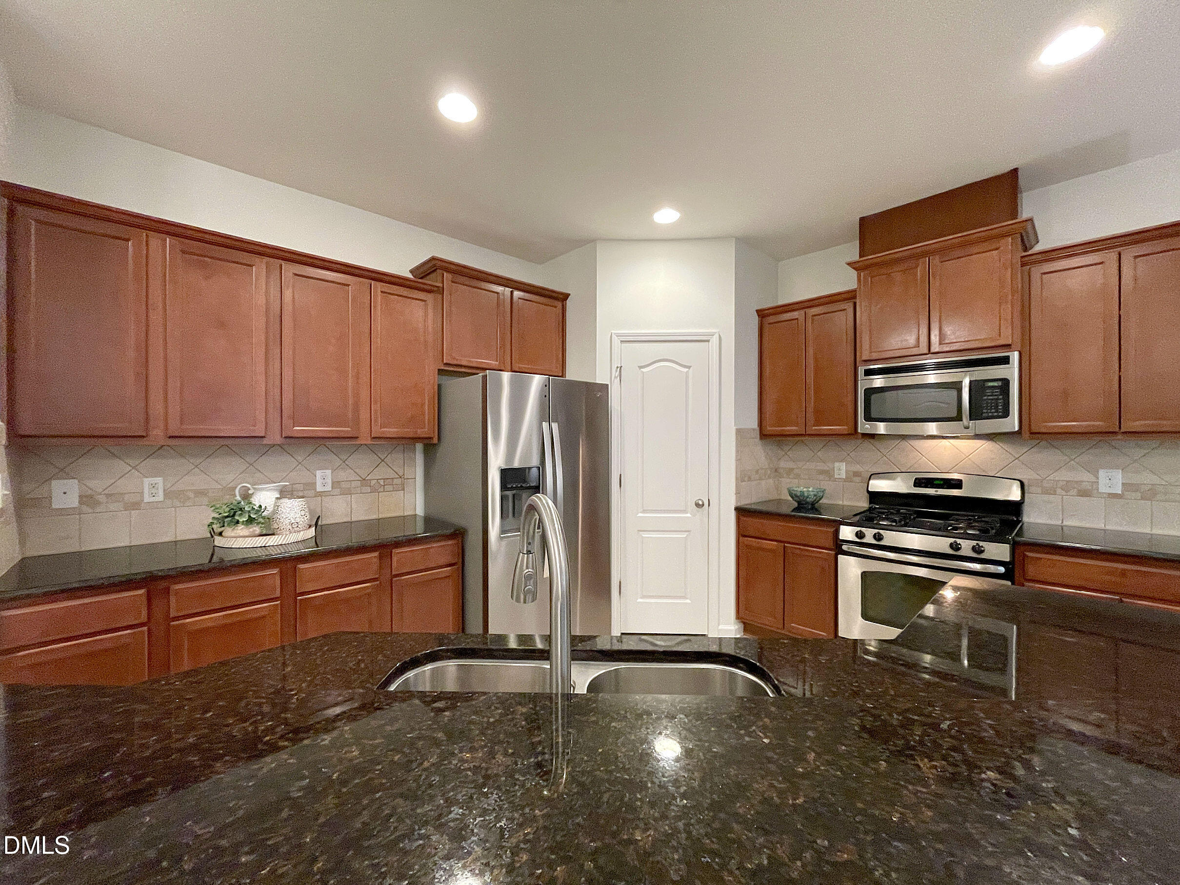 8257 Primanti Boulevard Raleigh, NC 27612 - Photo 12 of 27 a kitchen with stainless steel appliances granite countertop a refrigerator sink and stove