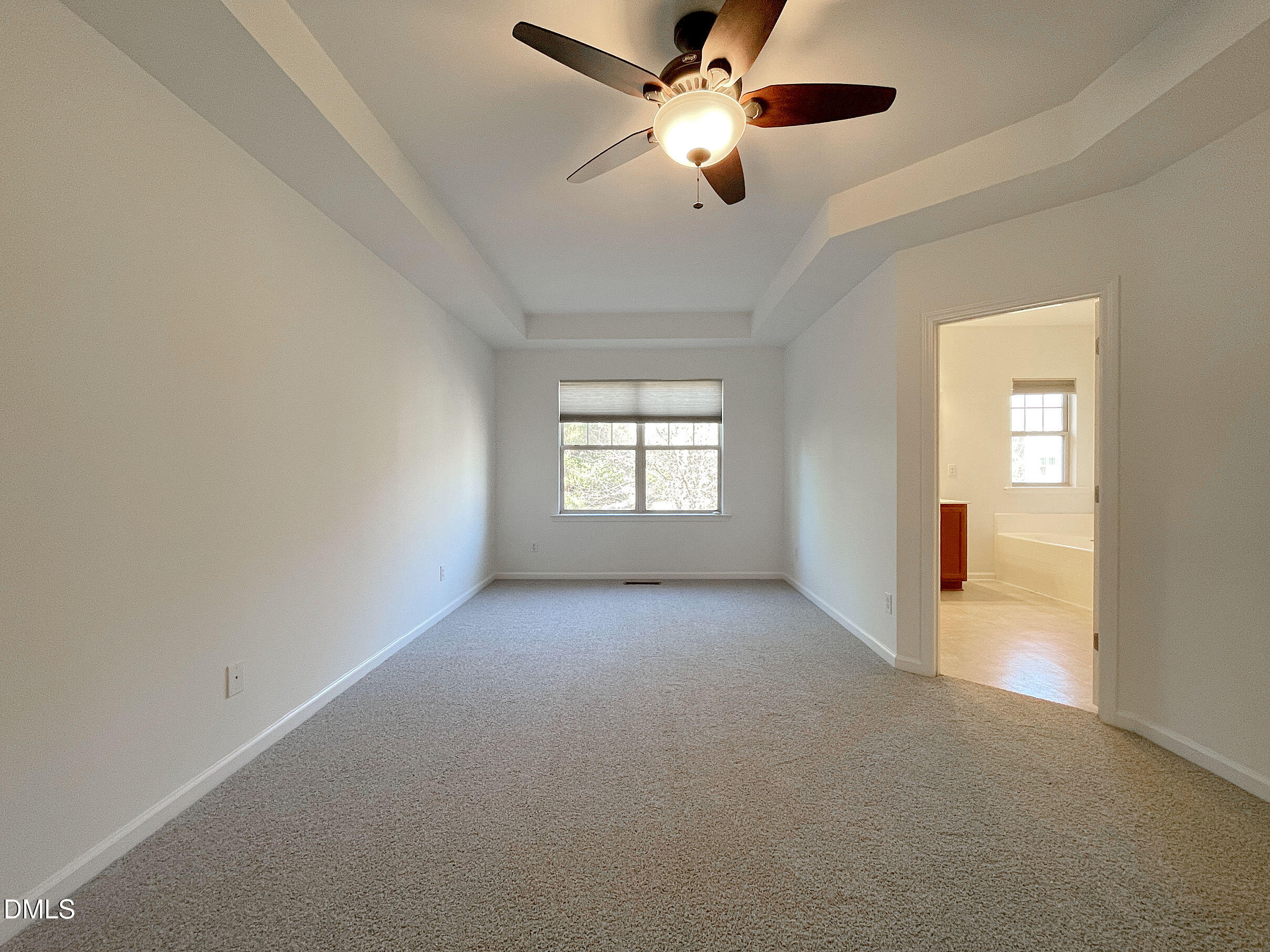 8257 Primanti Boulevard Raleigh, NC 27612 - Photo 14 of 27 en empty room with windows and ceiling fan