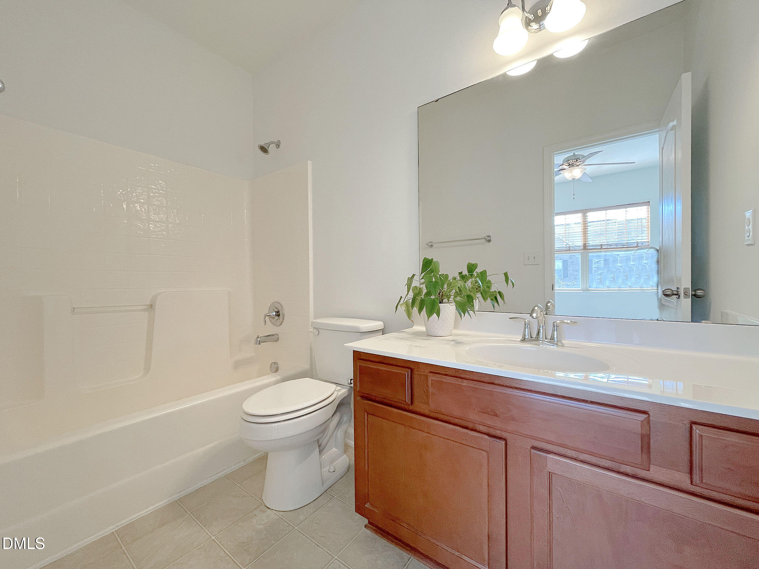 8257 Primanti Boulevard Raleigh, NC 27612 - Photo 20 of 27 a bathroom with a sink a toilet and a large mirror