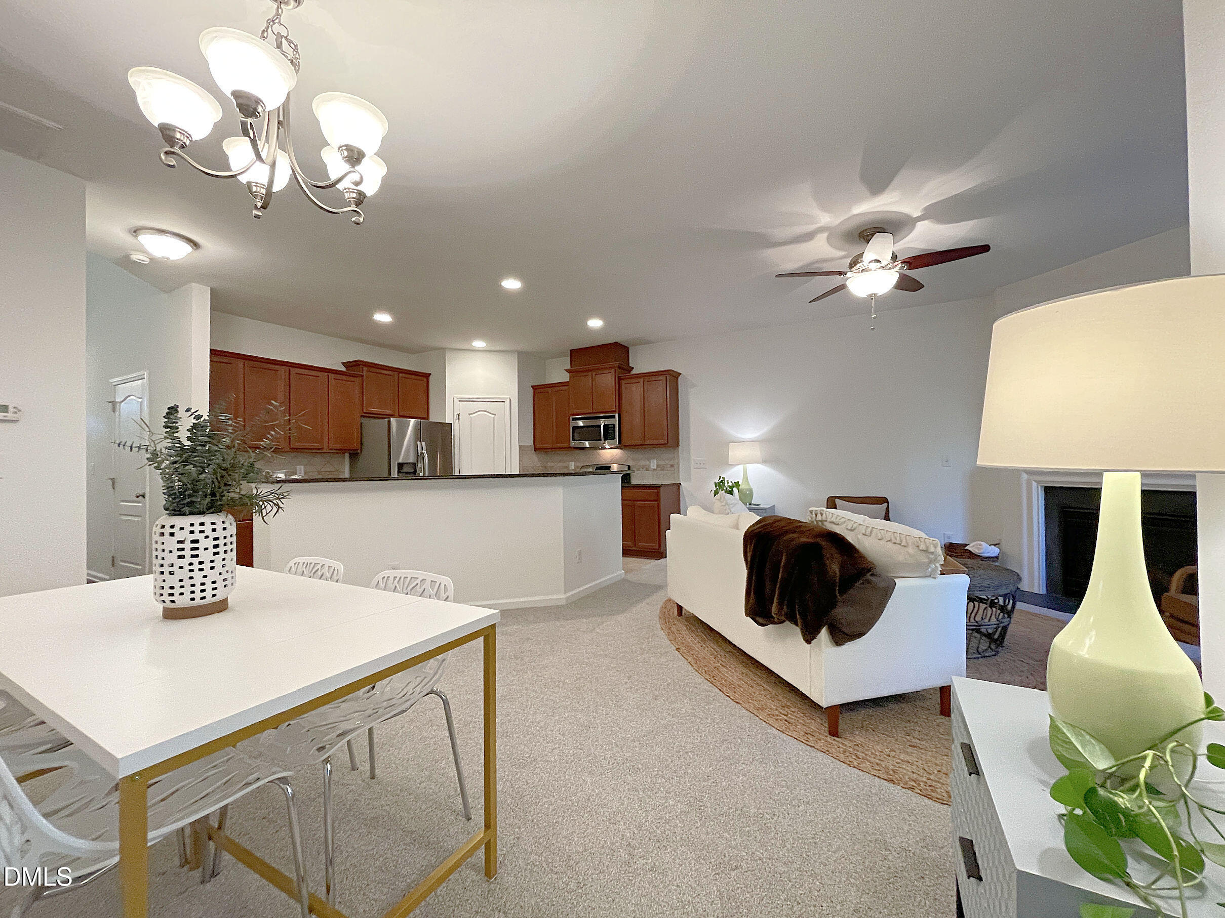 8257 Primanti Boulevard Raleigh, NC 27612 - Photo 6 of 27 a kitchen with a table a chandelier and living room view