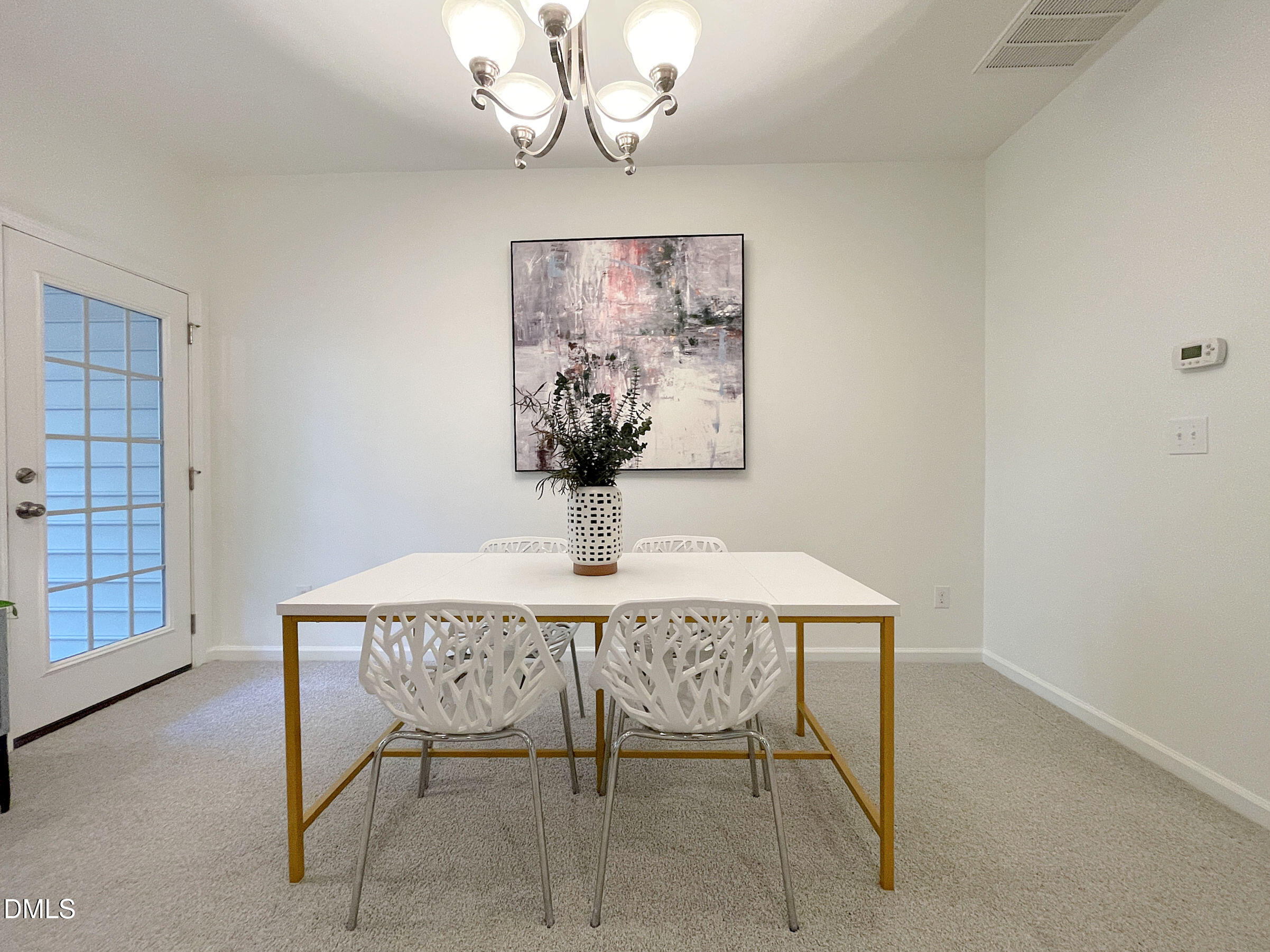 8257 Primanti Boulevard Raleigh, NC 27612 - Photo 7 of 27 a view of a dining room with furniture and chandelier