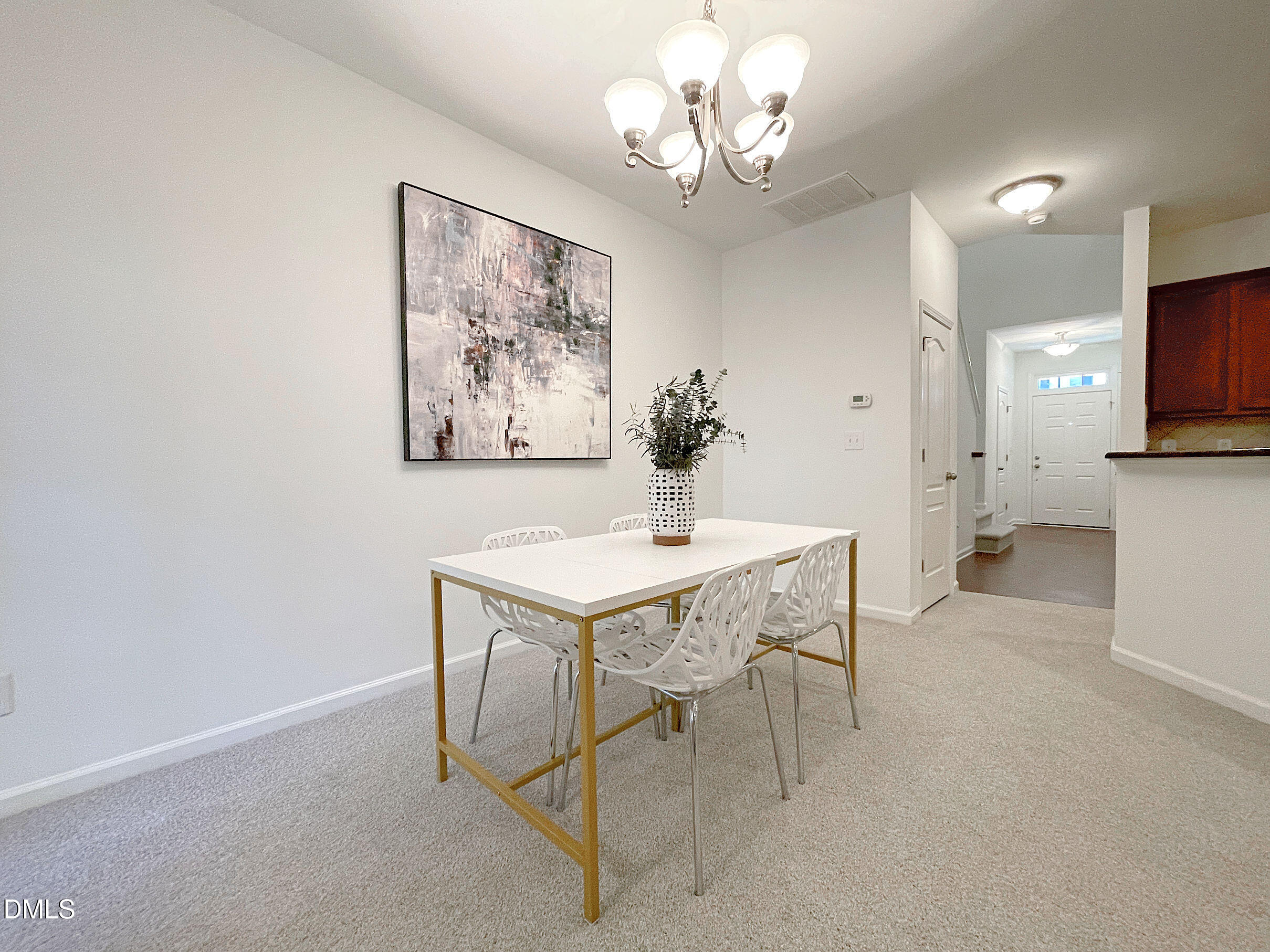 8257 Primanti Boulevard Raleigh, NC 27612 - Photo 9 of 27 a view of a dining room with furniture and a chandelier