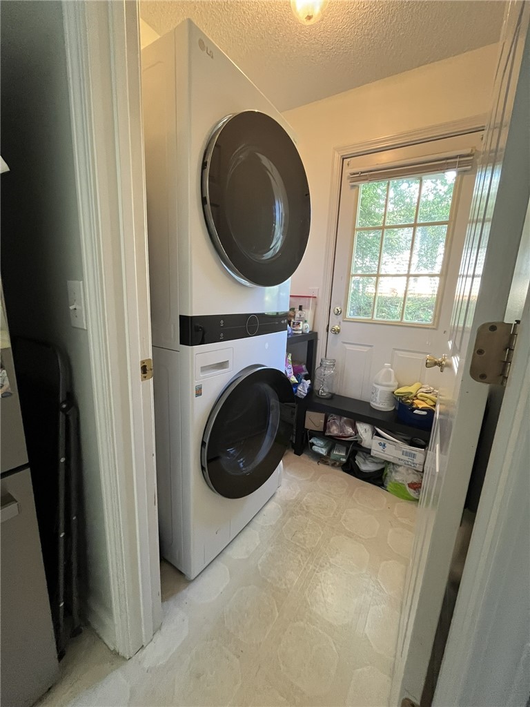 116 Arbors Court Central, SC 29630 - Photo 9 of 27 Functional laundry zone with stacked appliances and direct outdoor access.