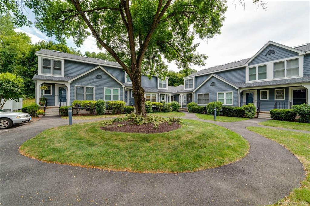 95 Fawn Ridge Lane, Unit 95 Norwalk, CT 06851 - Photo 1 of 1 a view of a house with a backyard patio and sitting area