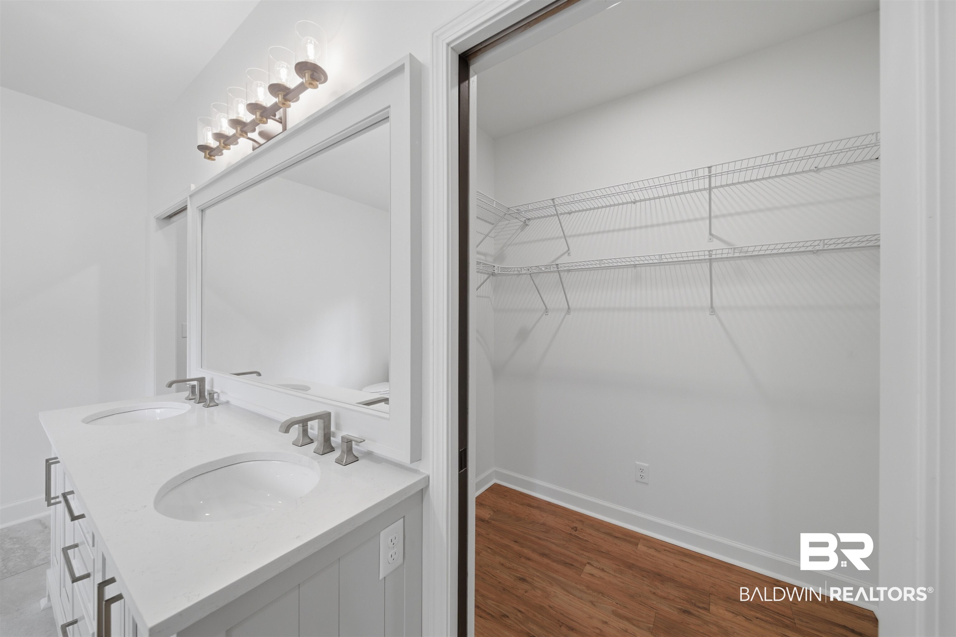 14128 Jackson Lane Foley, AL 36535 - Photo 25 of 36 Double vanity with undermount sinks, quartz-finish countertop, brushed nickel faucets, and a large framed mirror