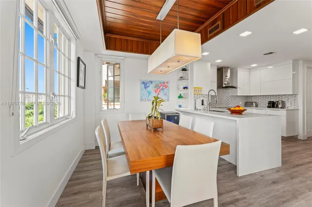 a living room with furniture a flat screen tv and a floor to ceiling window