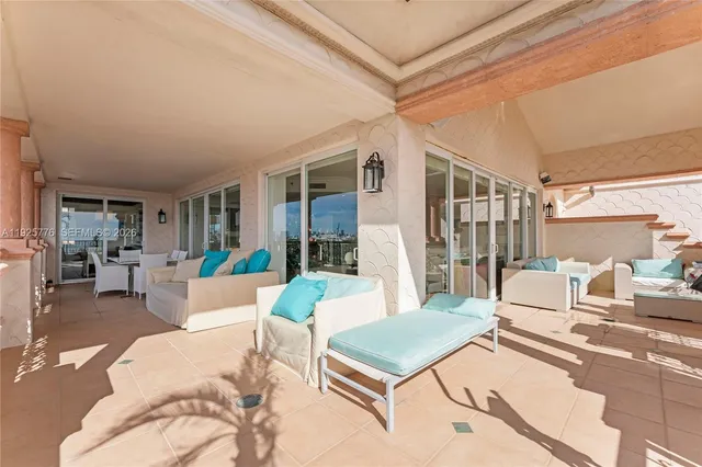 a bedroom with a bed a large window and a chandelier